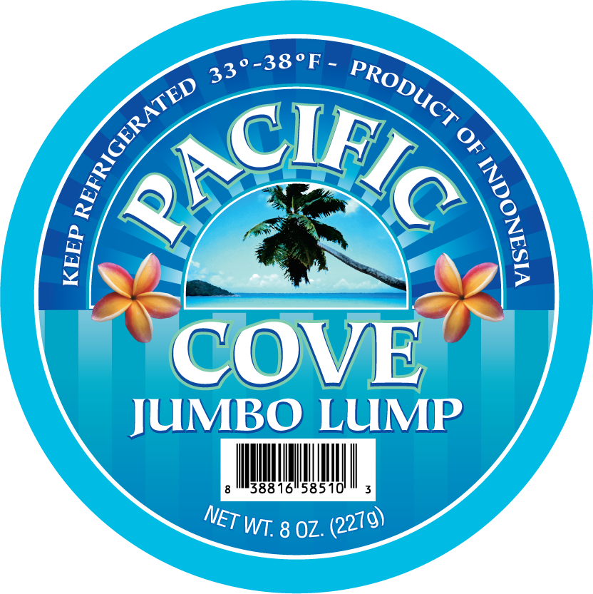 Round label for “Pacific Cove Jumbo Lump,” featuring palm tree, flowers, and a barcode, with blue as main color.