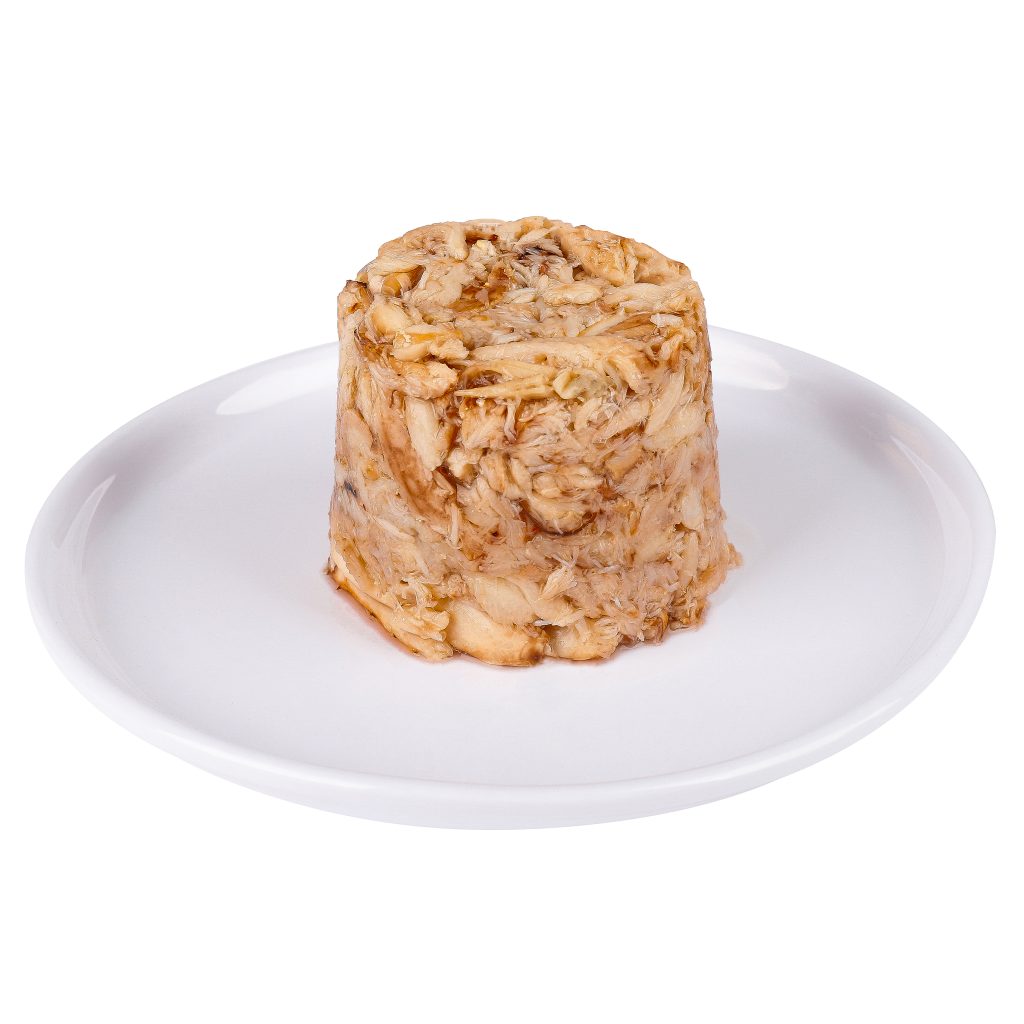 A mound of canned tuna on a white plate, isolated on a white background.