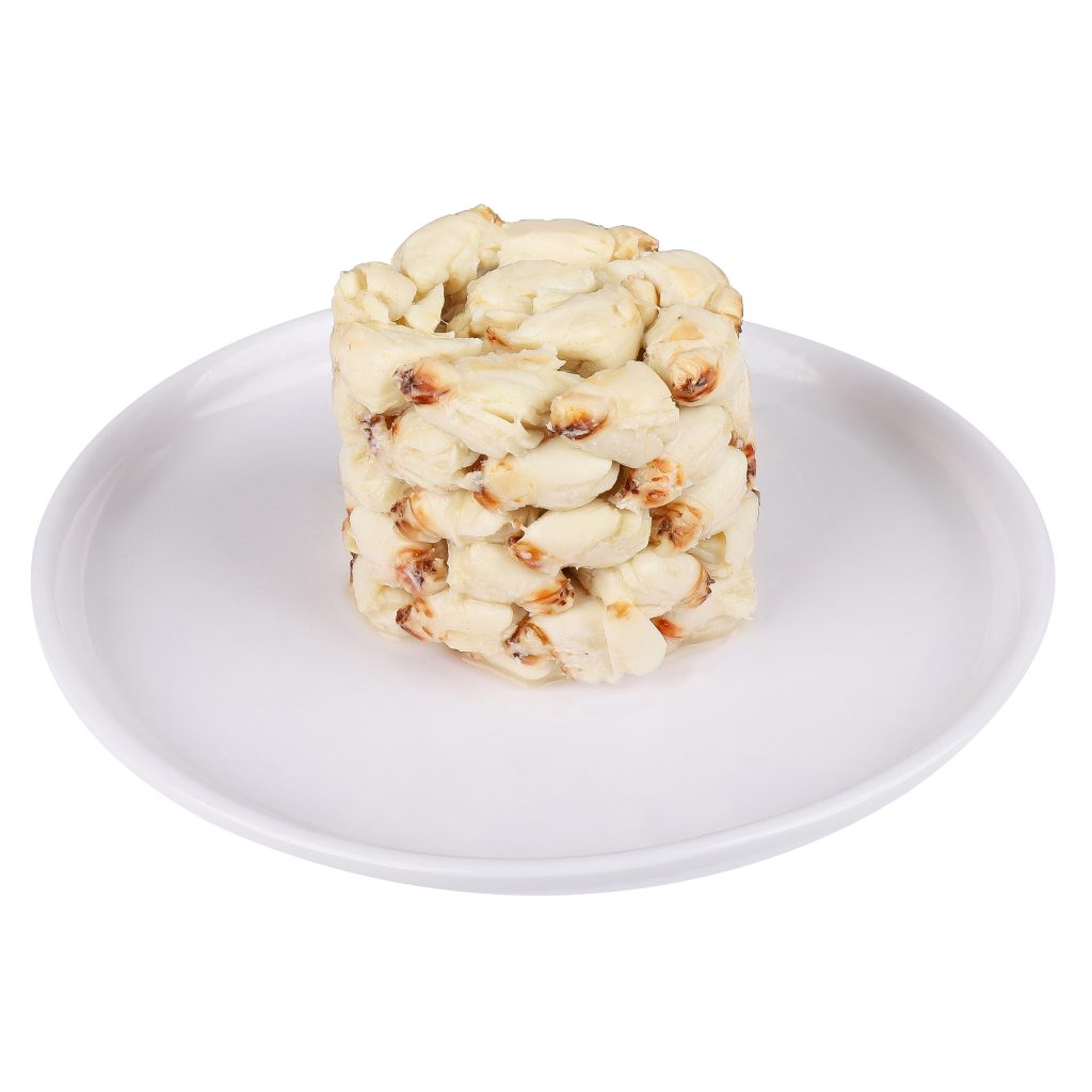 A round stack of popcorn on a white plate, isolated on a white background.